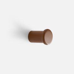 a brown door knob on a white wall