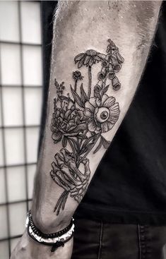 a man with a flower tattoo on his arm