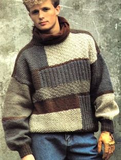 a young man is wearing a sweater and gloves while standing in front of a concrete wall