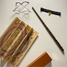 harry potter's wand, eyeglasses and money on a table