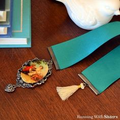 a close up of a key chain on a table with a teapot and other items