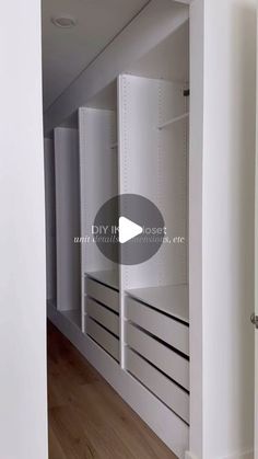 an empty walk in closet with white cabinets