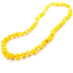 a yellow beaded necklace on a white background