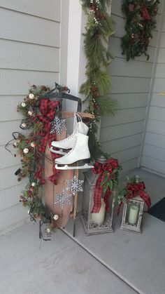 the front porch is decorated for christmas with holiday decorations and wreaths, including white booties