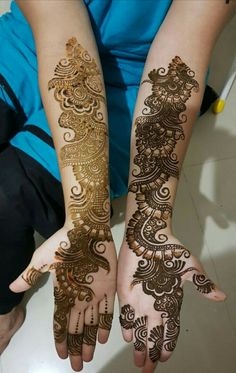 two hands with henna designs on them