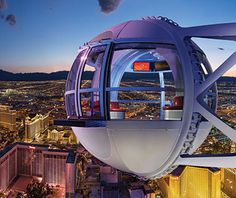 people standing on the top of a ferris wheel at night in las vegas, nevada