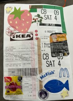 an open book with stickers and other items on the pages, including a mcdonald's ticket