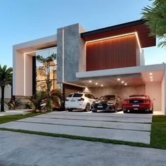 two cars parked in front of a modern house