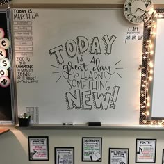 a white board with writing on it in front of several framed pictures and clocks around it