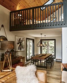 a living room filled with furniture and a wooden ceiling