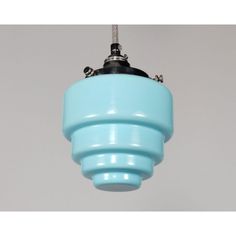 a blue light fixture hanging from a ceiling