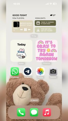 the teddy bear is sitting on top of the phone's keyboard and has stickers all over it