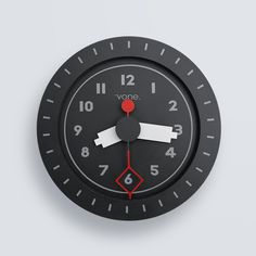 a black clock with red hands and the word voie on it's face