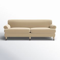 a beige couch sitting on top of a white floor