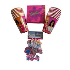 barbie party supplies including pink paper cups and napkins