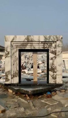 a white and black marble structure sitting on top of a pile of rubble