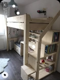 there is a bunk bed with stairs to the bottom and bookshelf on top