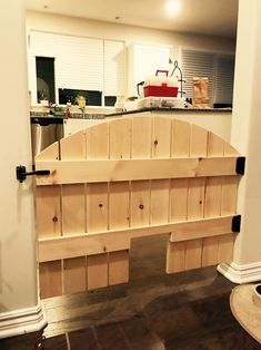 an open kitchen door with wooden shelves on the side and a counter top in the background