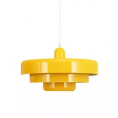 a yellow pendant light hanging from a ceiling