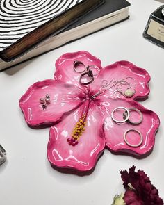 a pink flower shaped object sitting on top of a table