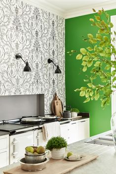 a kitchen with green walls and white cabinets