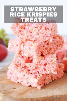 strawberry rice krispies treats stacked on top of each other with strawberries in the background