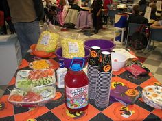 the table is full of halloween food and drinks for guests to enjoy at an event