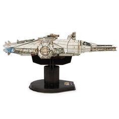 a model of a star wars ship on a black stand with a white back ground