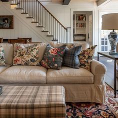 Modern cottage interior, mixing textures and patterns, including floral fabrics, stripes, checks, wood, and linen, creating a rich, layered look that complements the overall color palette3 House Architecture Styles