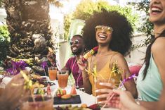 a group of people sitting around a table with drinks