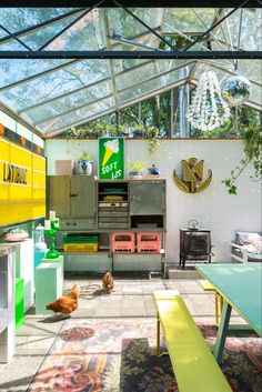 an outdoor kitchen with lots of green and yellow furniture