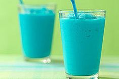 two glasses filled with blue liquid on top of a table