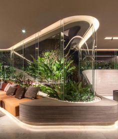 a living room filled with lots of furniture next to a large planter on the wall