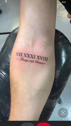 a person with a tattoo on their foot that reads vixvi xxviii