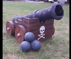 there is a pirate cannon and balls in the grass