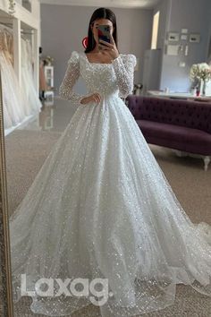 a woman taking a selfie in a wedding dress with her cell phone up to her ear