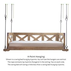 an image of a wooden swing bed with four hanging bars and pillows on the back