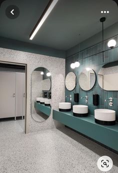 a public restroom with sinks and mirrors