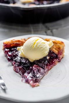 a slice of blueberry pie with ice cream on top