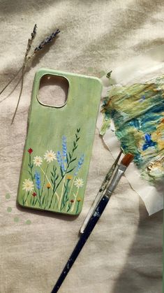 a paintbrush sitting on top of a piece of paper next to an easel