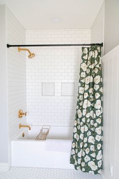 a bathroom with a tub, shower curtain and tiled floor