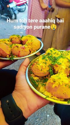 two people holding plates with food on them