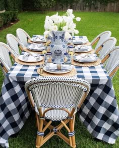 the table is set up with blue and white checkered cloths on it,