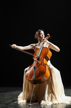 a woman in white dress playing an instrument