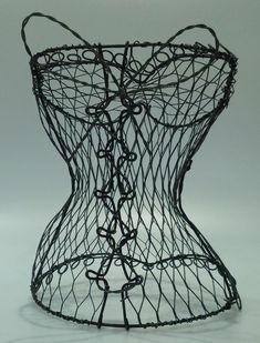 a wire sculpture sitting on top of a white table