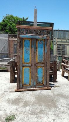 an old wooden door sitting in the sand