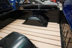 the inside of a pickup truck with wood flooring