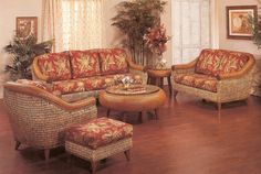 a living room filled with furniture on top of a hard wood floor covered in wicker