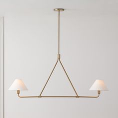 a light fixture with three lamps hanging from it's sides in a white room