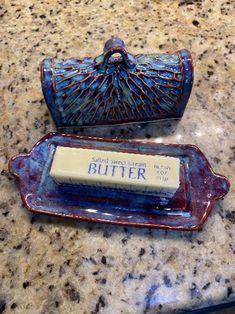 two blue dishes sitting on top of a counter